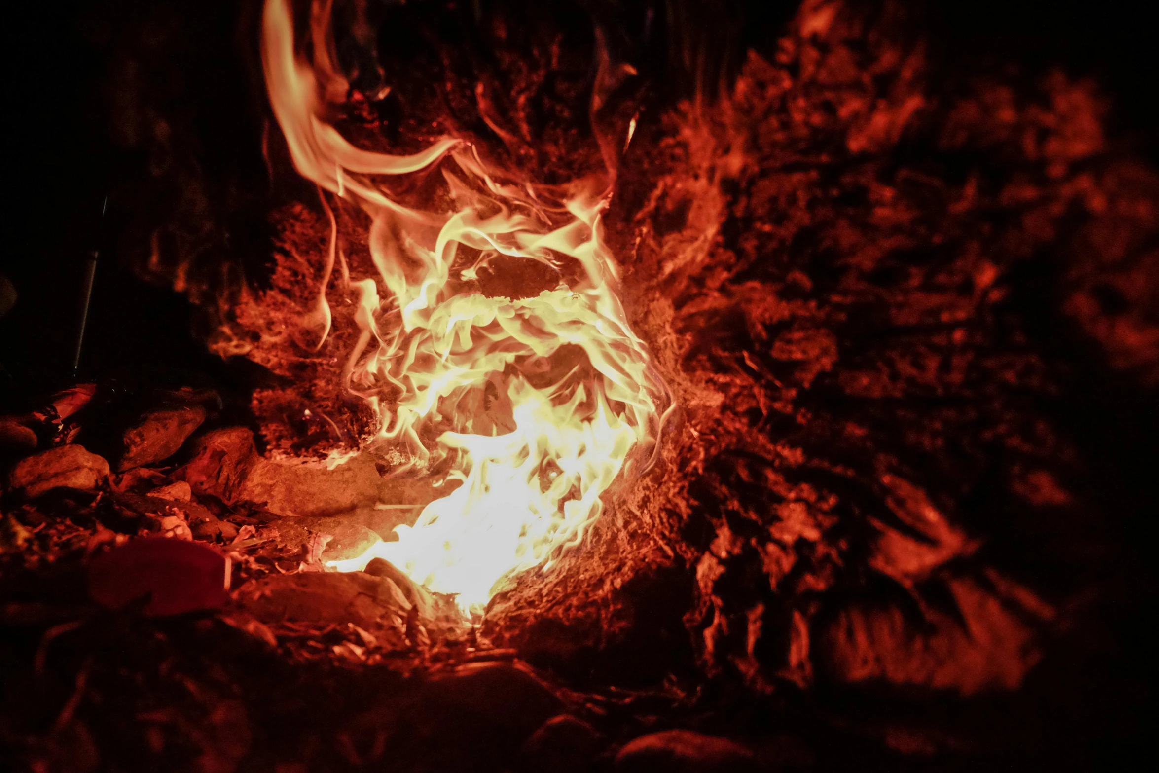 a close up of a fire in the dark, by Daniel Lieske, pexels contest winner, process art, inside of a cave, bright orange camp fire, instagram post, animation