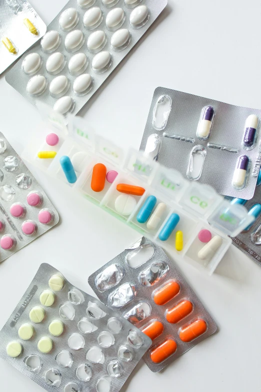 a bunch of pills sitting on top of a table, inspired by Damien Hirst, unsplash, plasticien, medical labels, detailed product shot, panels, ready - made