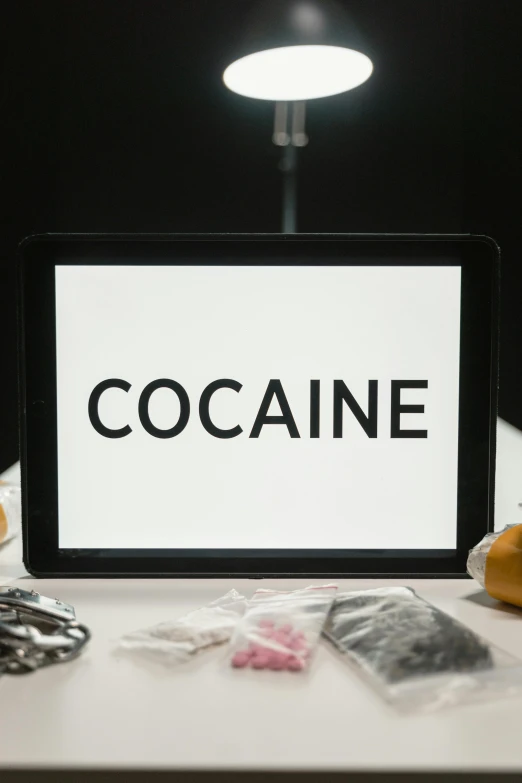 a tablet computer sitting on top of a table, a cartoon, by Everett Warner, trending on unsplash, graffiti, cocaine, barbara kruger, medicine, high quality photo