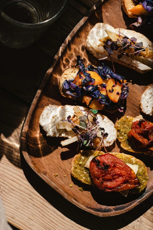 a close up of a plate of food on a table, by Carey Morris, unsplash, renaissance, woodfired, toast, on a wooden tray, chilean