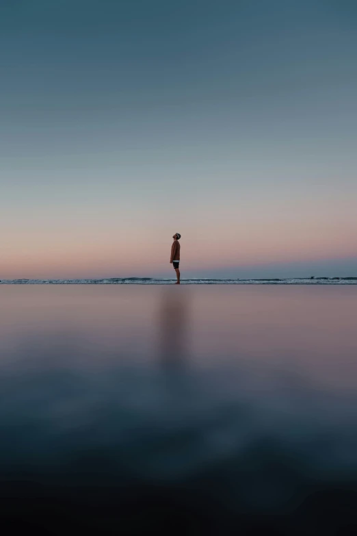 a person standing on top of a beach next to the ocean, unsplash contest winner, minimalism, calm evening, stands in a pool of water, little kid, trailing off into the horizon