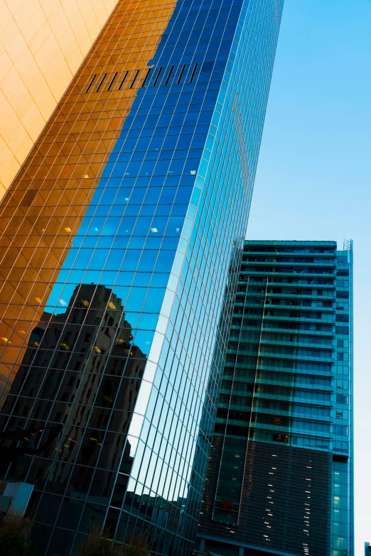 a couple of tall buildings sitting next to each other, a picture, by Doug Ohlson, glass reflections, crisp lines and color, square, high quality photo