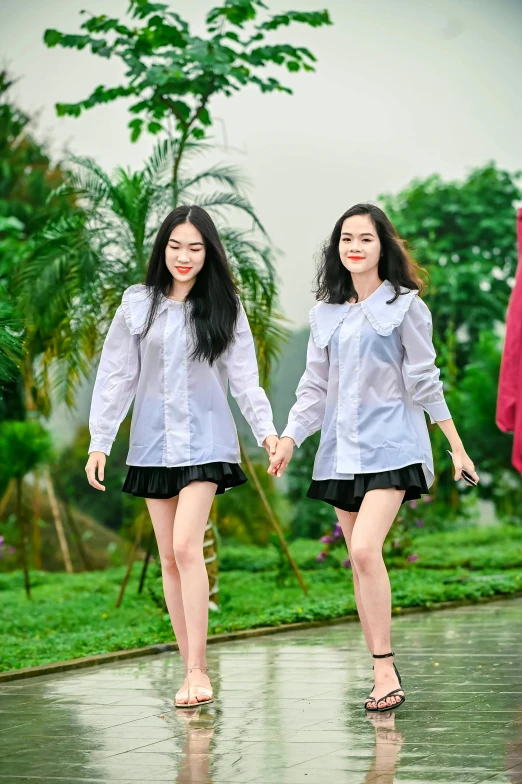 two women walking in the rain with umbrellas, unsplash, happening, in style of lam manh, wearing a school uniform, holding hands, ( ( theatrical ) )