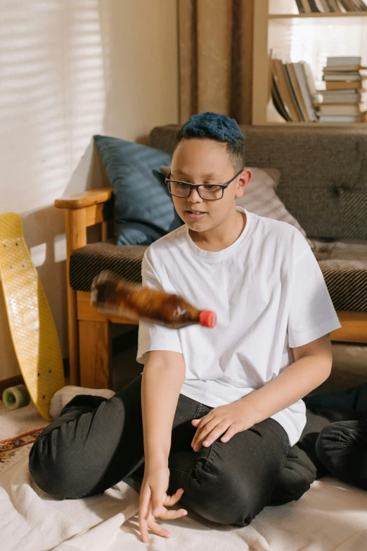 a man sitting on the floor has soing in his hand