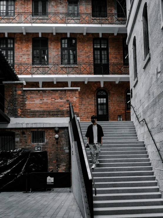 a man riding a skateboard down a flight of stairs, inspired by Gang Hui-an, pexels contest winner, old buildings, background image, gloomy mood, courtyard walkway