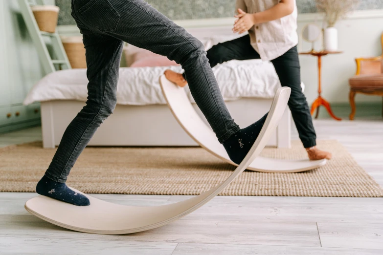 a couple of people that are standing in a room, inspired by Constantin Hansen, trending on pexels, arabesque, man riding a giant mouse, kids playing, wooden supports, curved furniture