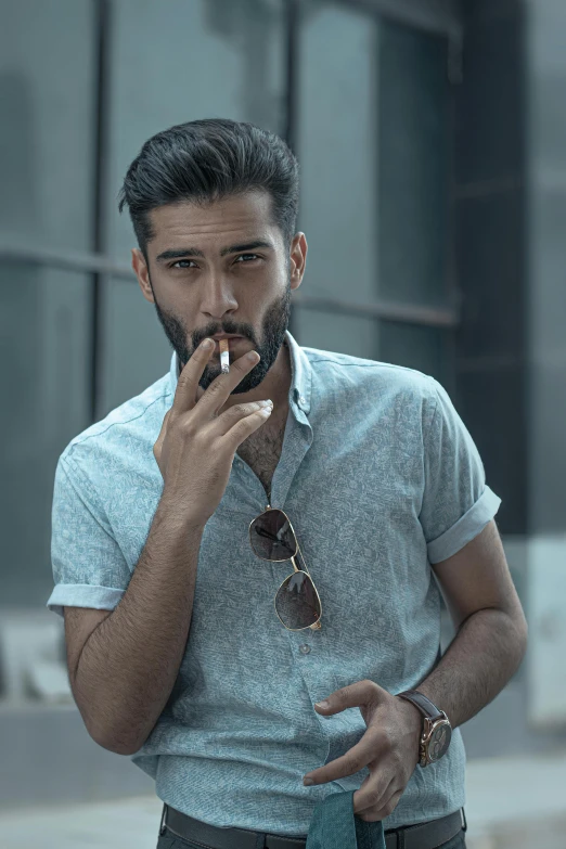 a man smoking a cigarette in front of a building, a colorized photo, pexels contest winner, chest hair, wearing a light blue shirt, on grey background, sayem reza