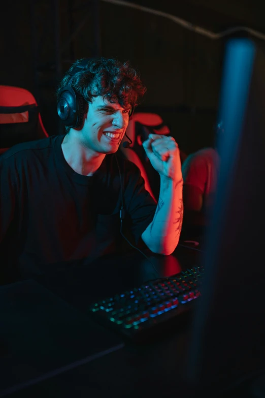 a man wearing headphones sitting in front of a computer, game ready, smiling male, bizzaro, edited