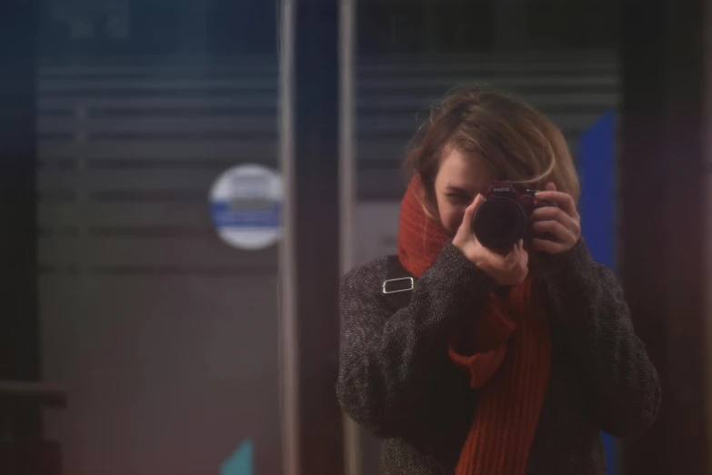 a woman taking a picture of herself in a mirror, pexels contest winner, photorealism, calm night. over shoulder shot, shot on red camera, street photography style, still from a movie