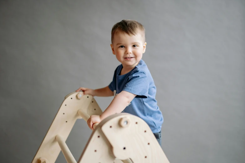 a little boy standing on top of a wooden horse, unsplash, conceptual art, activity play centre, portrait image, arched back, blue print