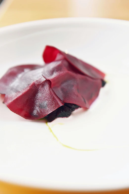 a close up of a plate of food on a table, puce and vermillion, with a white background, square, beets