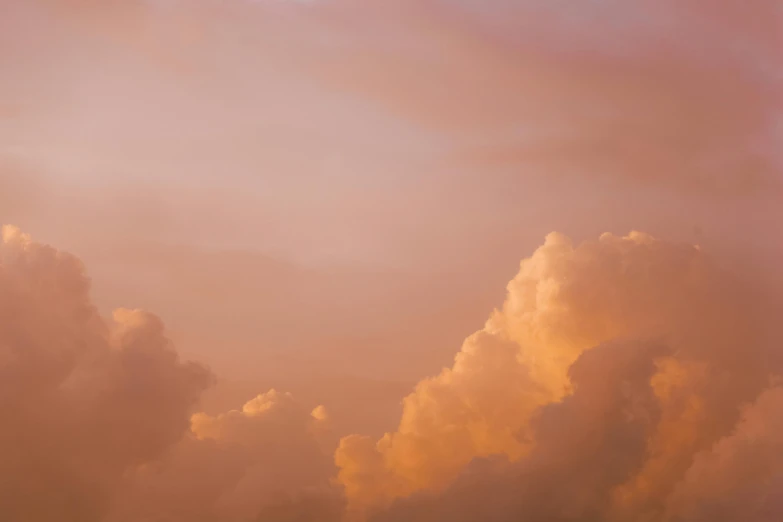 a large jetliner flying through a cloudy sky, by Carey Morris, unsplash, romanticism, toned orange and pastel pink, cumulus, humid evening, heaven pink