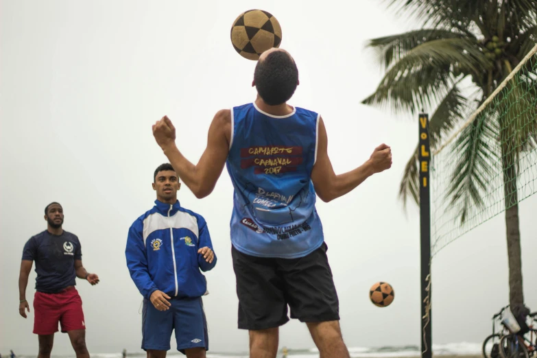 a group of young men playing a game of soccer, jair bolsonaro, standing near the beach, profile image, pictured from the shoulders up