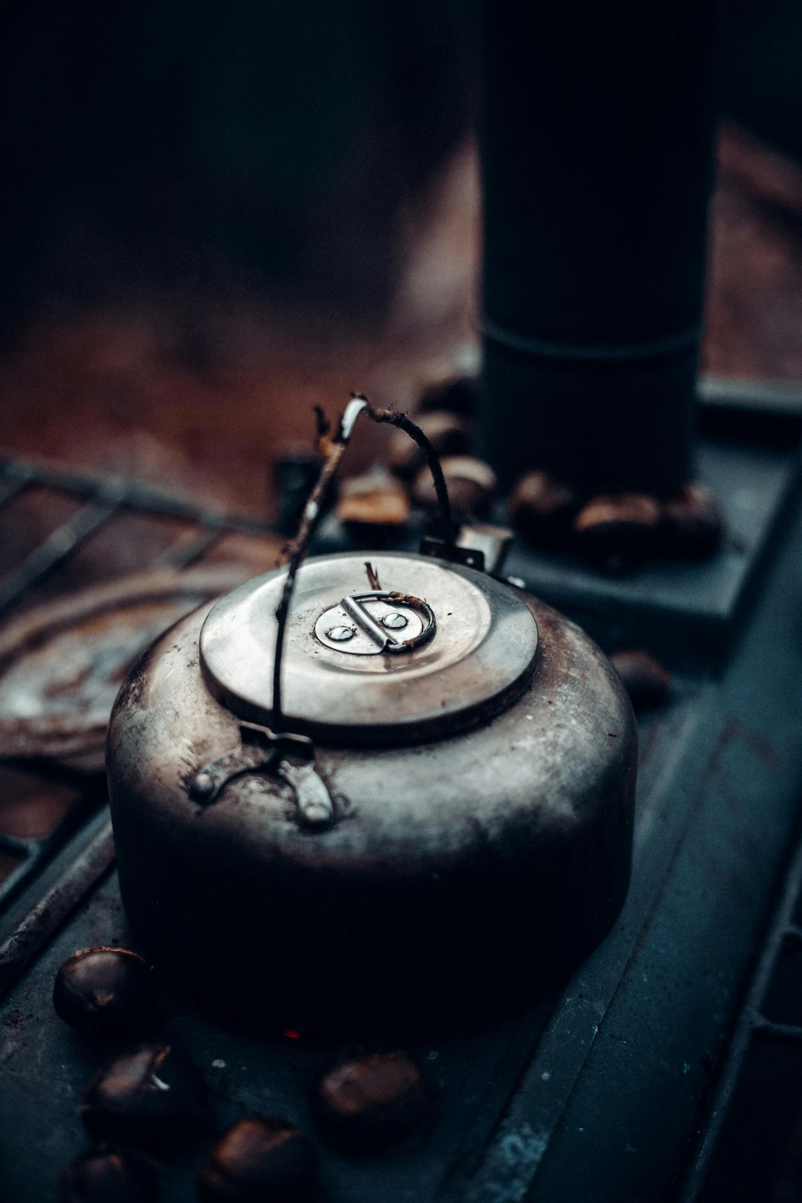 a tea kettle sitting on top of a wooden table, by Jan Tengnagel, trending on pexels, auto-destructive art, postapocalyptic vibes, stove, high angle close up shot, lantern