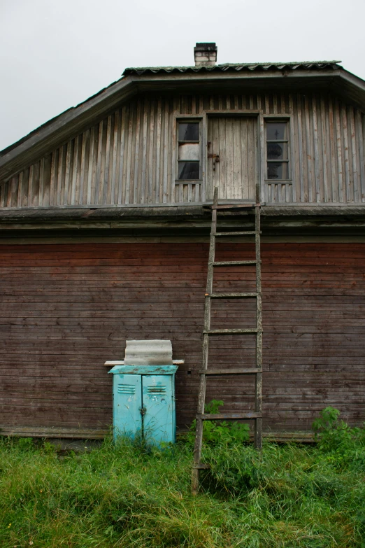 an old barn with a ladder in front of it, inspired by Isaac Levitan, unsplash, vintage fridge, poop, russian style, full frame image