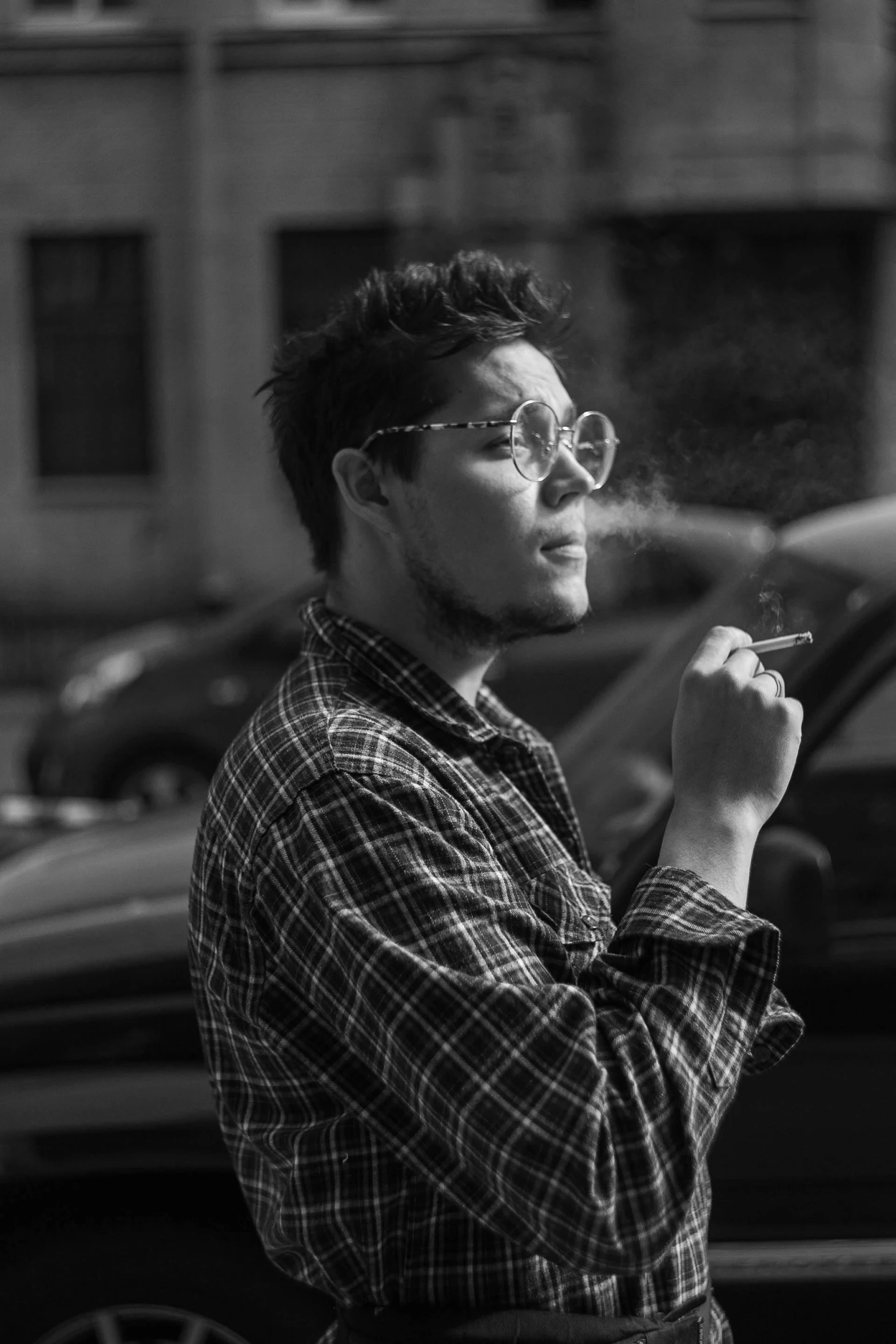 a black and white photo of a man smoking a cigarette, a black and white photo, pexels contest winner, pete davidson, peter parker, flannel, jisu choe