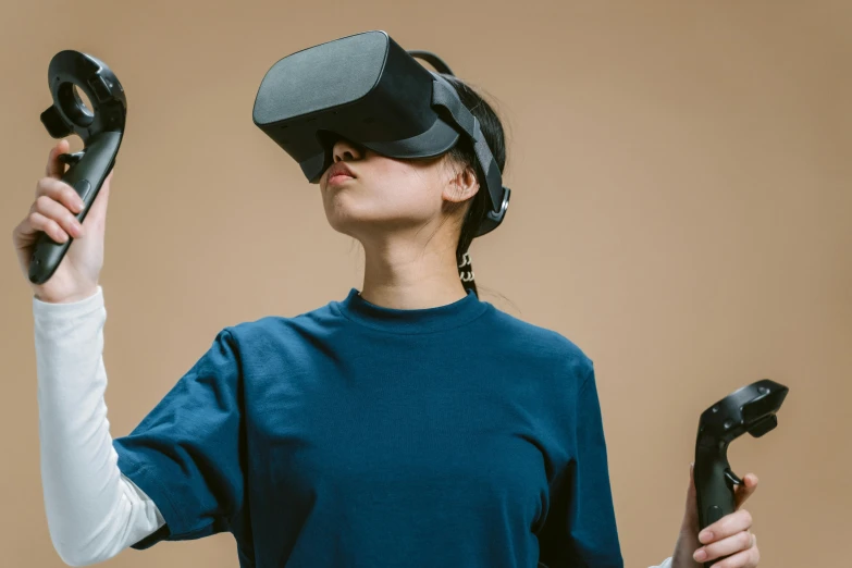 a woman wearing a virtual reality headset and holding two remotes, trending on unsplash, interactive art, navy, cardboard, avatar image