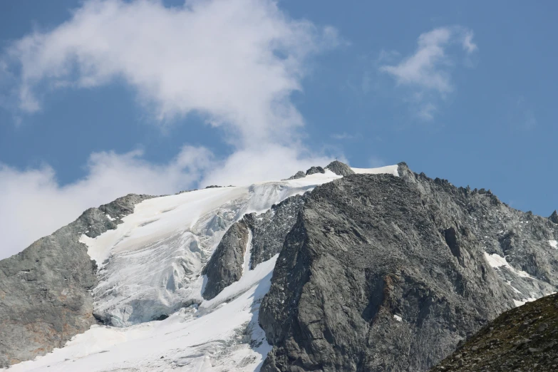 a man standing on top of a snow covered mountain, by Peter Churcher, pexels contest winner, les nabis, seen from a distance, carrara marble, slide show, 3/4 view from below