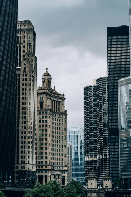 a city street filled with lots of tall buildings, a photo, by Dan Christensen, pexels contest winner, modernism, gothic architecture, from wheaton illinois, gray skies, chicago