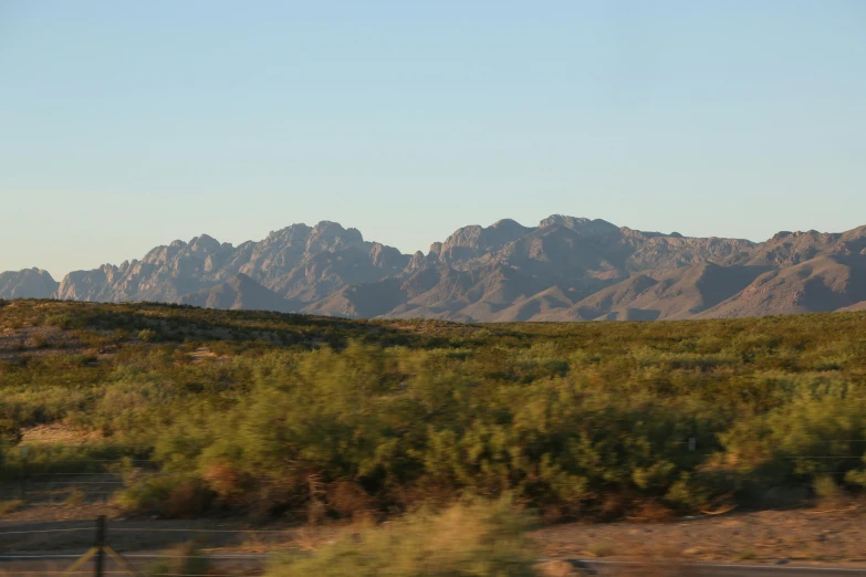 a view of the mountains from a moving car, by Linda Sutton, mexican mustache, bushes, mid shot photo, fan favorite