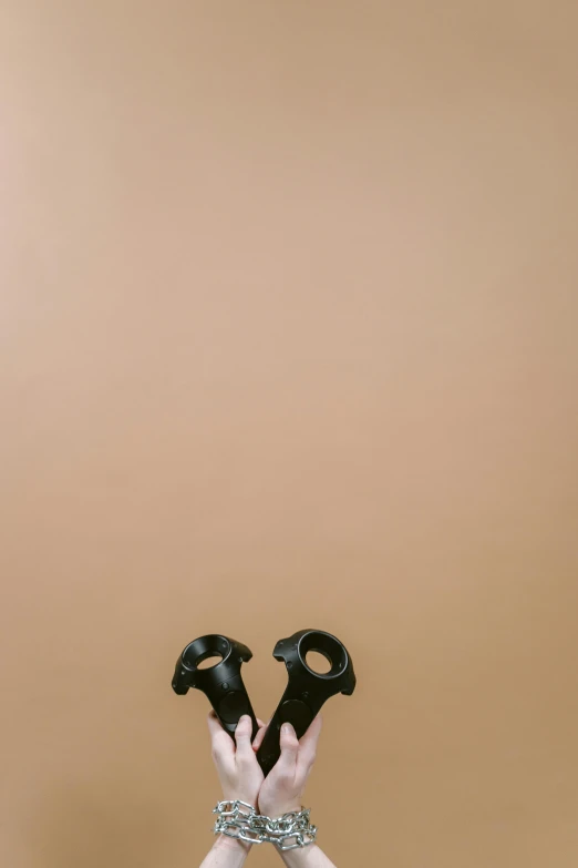 a woman doing a yoga pose with her hands in the air, an album cover, by Andries Stock, trending on pexels, holding maracas, minimalist wallpaper, black and brown, made of rubber