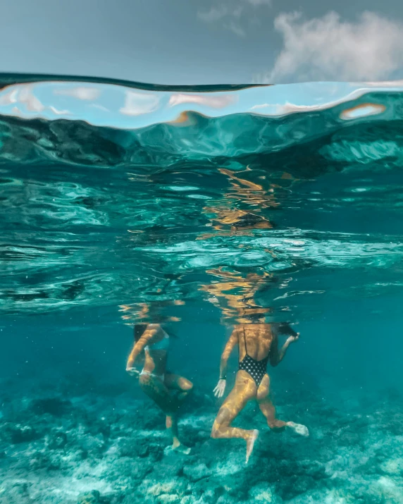 a couple of people swimming in the ocean, by Emma Andijewska, sumatraism, best photo, 🚀🌈🤩, bottom angle, lesbians