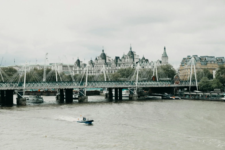 a boat traveling down a river next to a bridge, inspired by Thomas Struth, pexels contest winner, london south bank, 🚿🗝📝