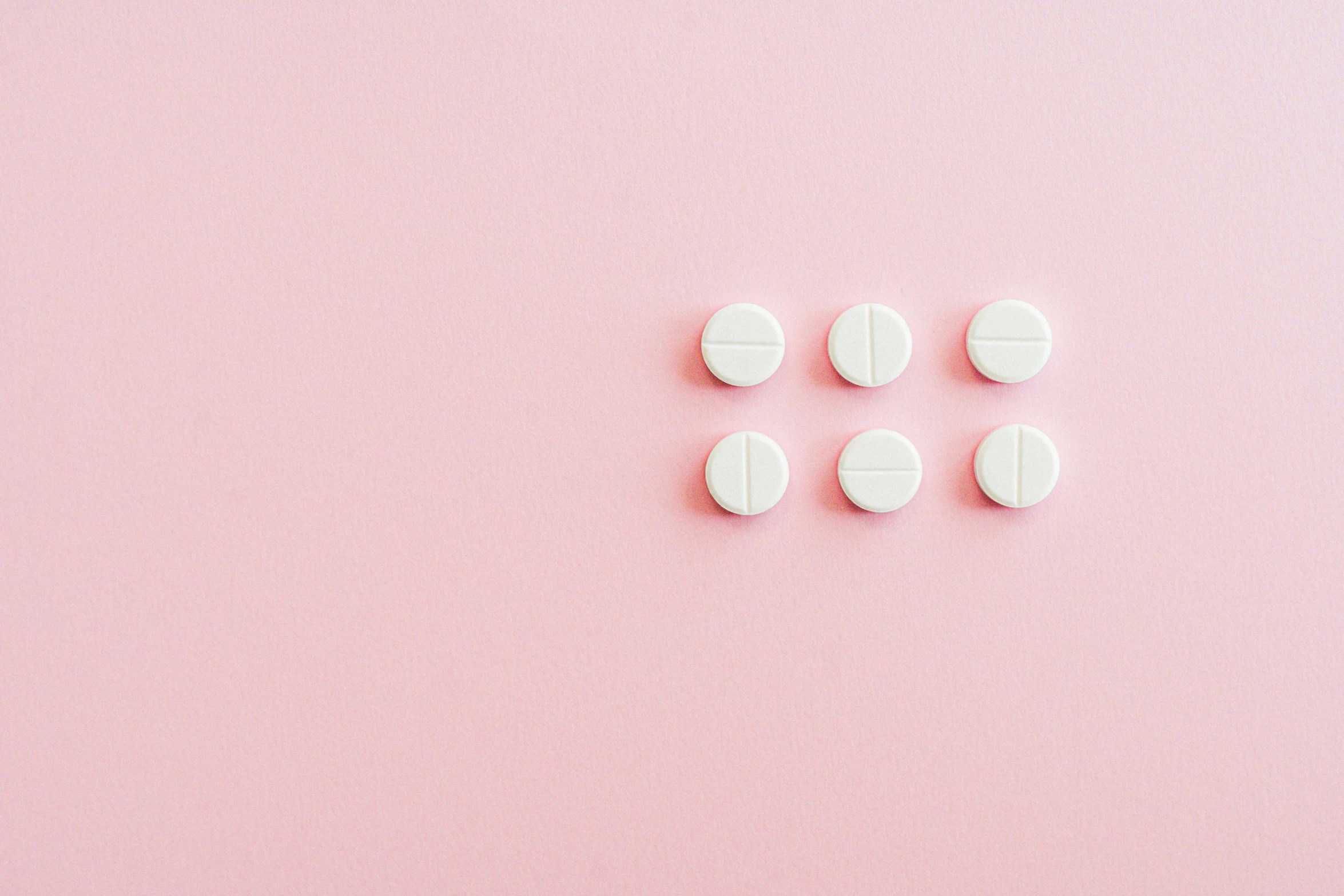 white pills on a pink background, by Emma Andijewska, trending on pexels, white panels, eight eight eight, a round minimalist behind, girls