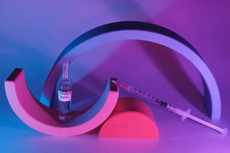 a syll sitting on top of a pink and blue background, an abstract sculpture, inspired by Évariste Vital Luminais, pexels contest winner, hypermodernism, syringes, purple and scarlet colours, healthcare, woamn is curved