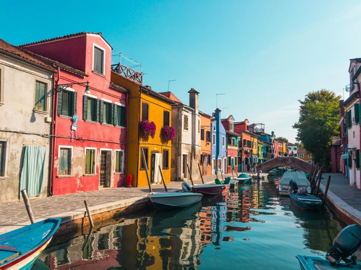 a row of boats sitting on the side of a river, inspired by Quirizio di Giovanni da Murano, pexels contest winner, colorful house, clear and sunny, thumbnail, overview