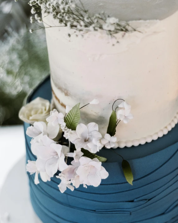 a white and blue wedding cake with baby's breath, by Grace Polit, trending on unsplash, manuka, ribbons, thumbnail, feature