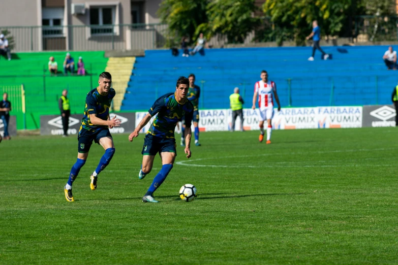 a group of young men playing a game of soccer, green and blue, 8k 50mm iso 10, gui guimaraes, high quality picture