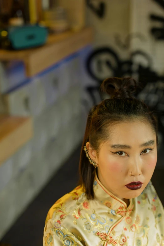 a woman sitting at a table with a plate of food, an album cover, inspired by Xie Huan, unsplash, hyperrealism, looking to camera, geisha hairstyle, high angle closeup portrait, ((portrait))