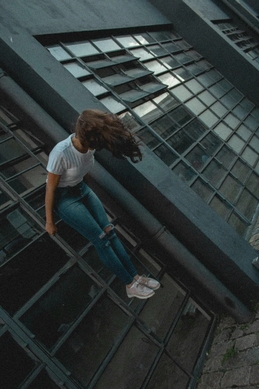 a woman flying through the air while riding a skateboard, a picture, pexels contest winner, happening, upside - down building, looking sad, glass floor, trending on vsco