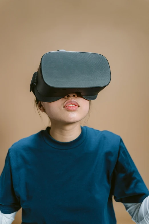 a woman in a blue shirt wearing a virtual reality headset, trending on unsplash, hypermodernism, portrait of a japanese teen, cardboard, siggraph, 2000s photo