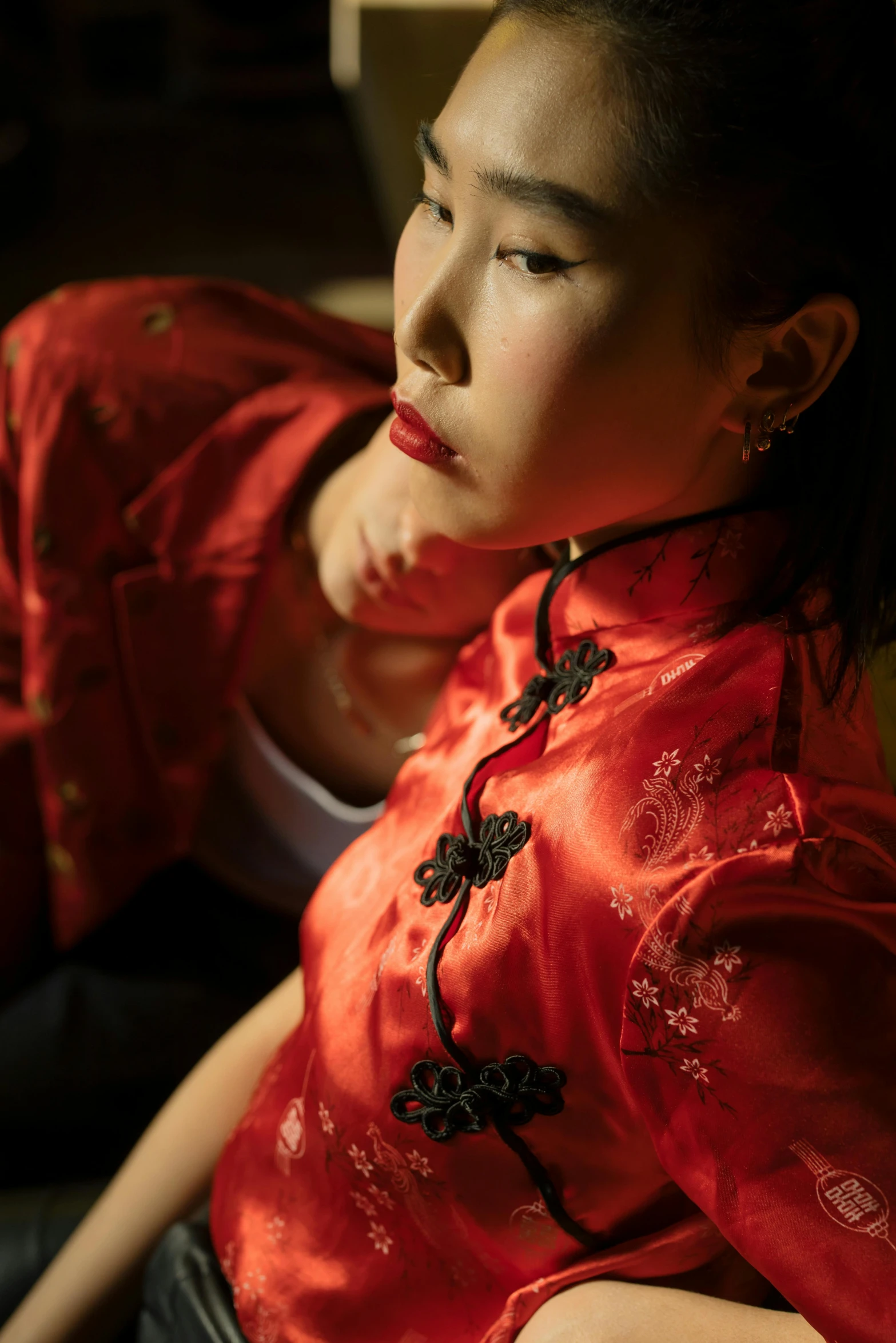 a woman sitting in front of a laptop computer, inspired by Xu Xi, art photography, red clothes, warm moody lighting, jewelry, 奈良美智