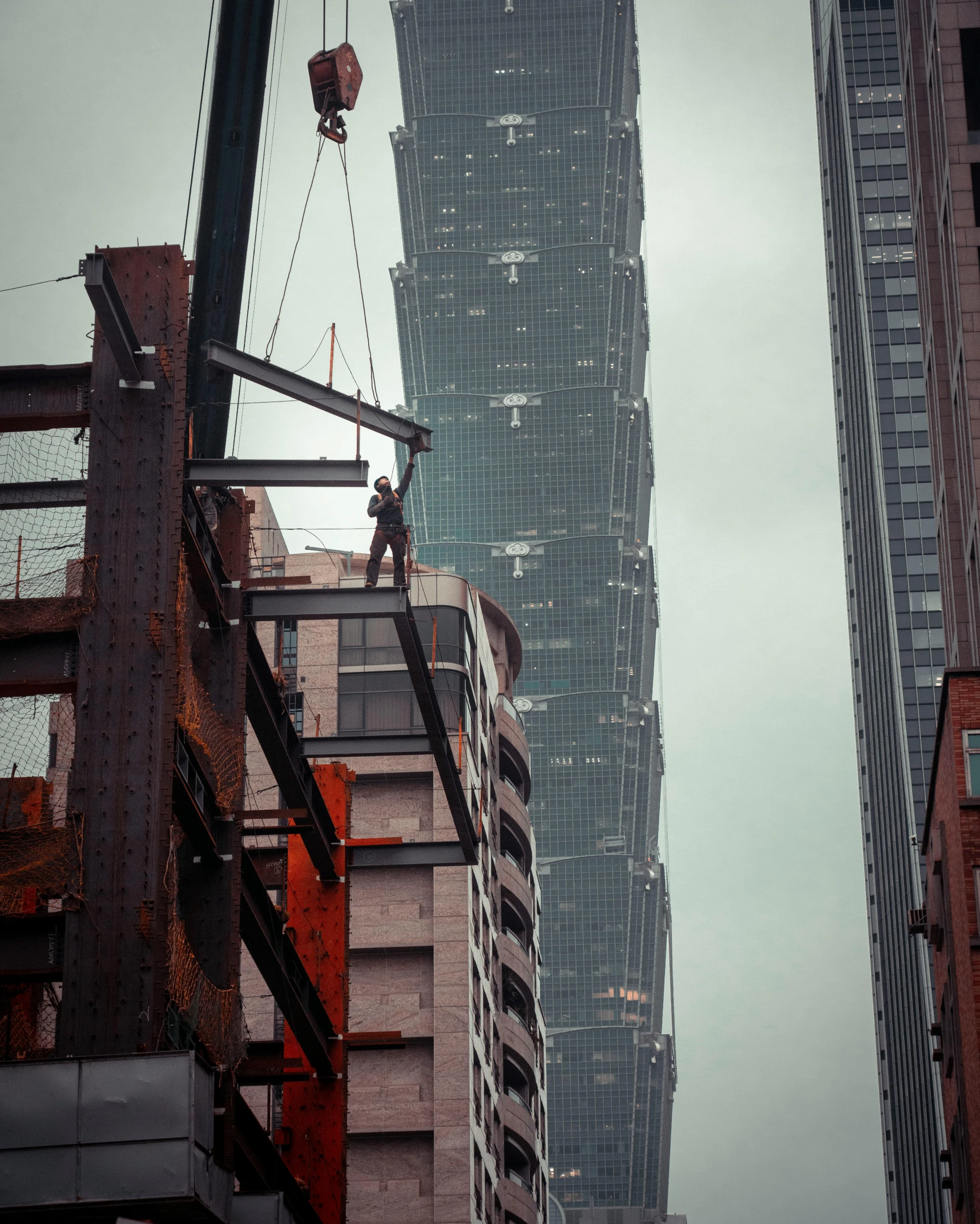 a tall building under construction in a city, a photo, inspired by Cheng Jiasui, pexels contest winner, constructivism, bladerunner in the rain, mid-shot of a hunky, superhero, reassuring