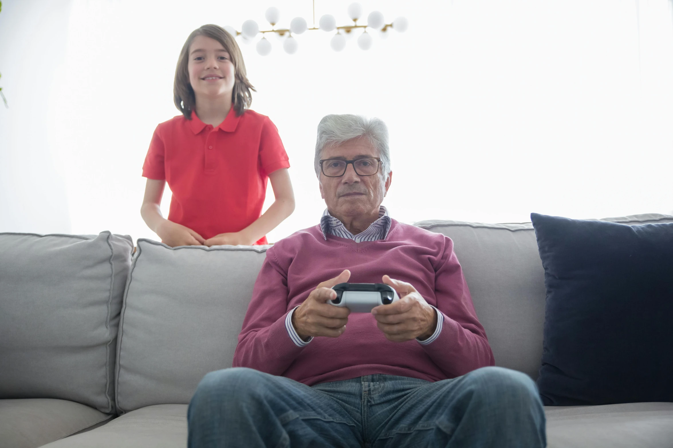 a man sitting on top of a couch holding a nintendo wii game controller, pexels contest winner, grandfatherly, medium shot of two characters, teenage boy, sport game