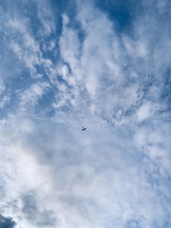 a plane flying through a cloudy blue sky, by Niko Henrichon, pexels contest winner, helicopters, low quality photo, hd footage