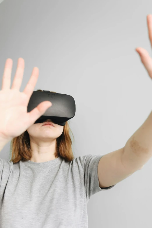 a woman wearing a virtual reality headset, by Carey Morris, pexels, wave a hand at the camera, square, siggraph, very expressive