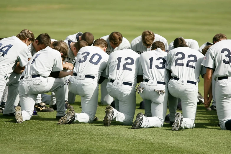 a group of baseball players kneeling in a huddle, religious, 9/11, college, screensaver