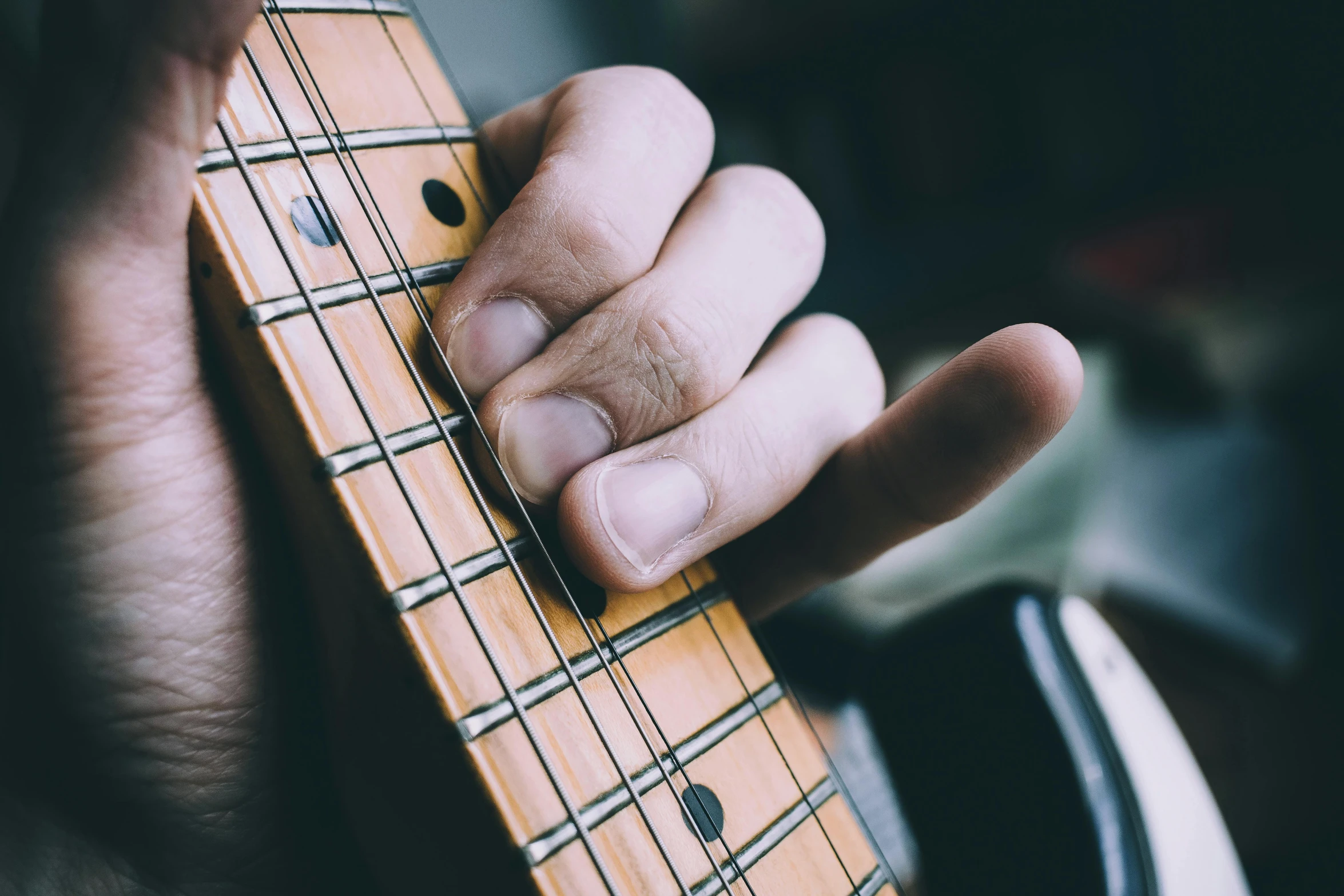 a close up of a person playing a guitar, by Joe Bowler, trending on pexels, realism, five fingers on the hand, digitally remastered, bumpy skin, rectangle