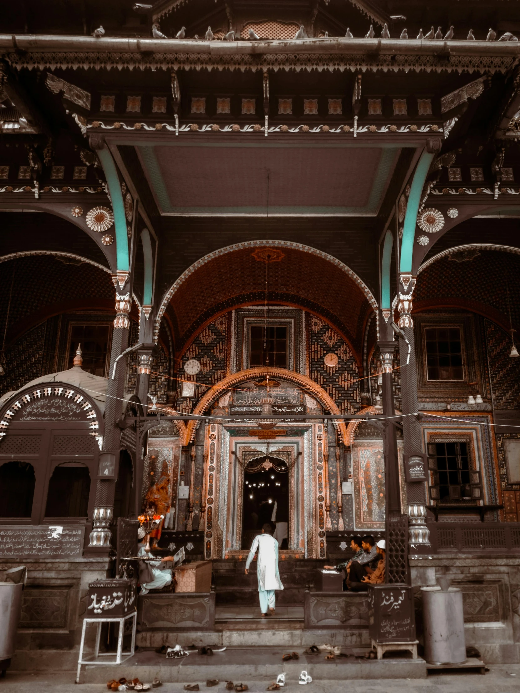 a person standing in front of a building, by Julia Pishtar, pexels contest winner, sumatraism, hindu aesthetic, brown and white color scheme, ornate cyberpunk interior, front facing!!!