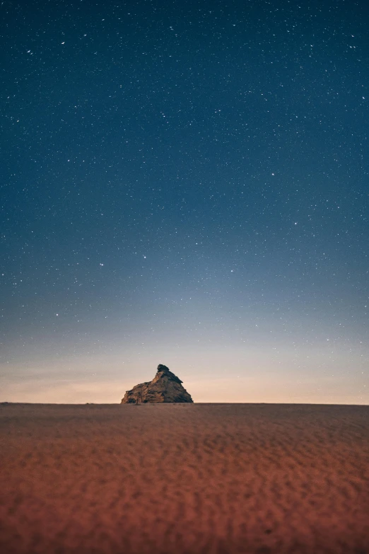 a lone rock in the middle of a desert, unsplash contest winner, minimalism, set in observatory at night, building in the distance, blue sand, slightly pixelated