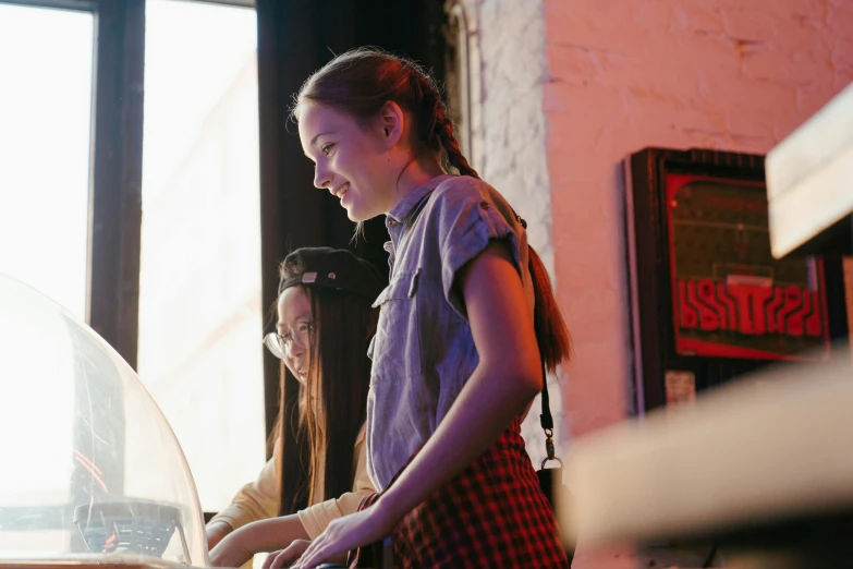 a woman standing in front of a laptop computer, pexels, interactive art, mackenzie foy, cash register, dj at a party, aussie baristas