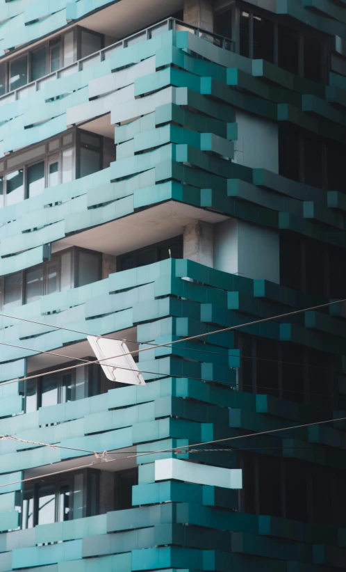 a traffic light in front of a tall building, by Matija Jama, pexels contest winner, modernism, cyan shutters on windows, panoramic anamorphic, mexico city, folded geometry