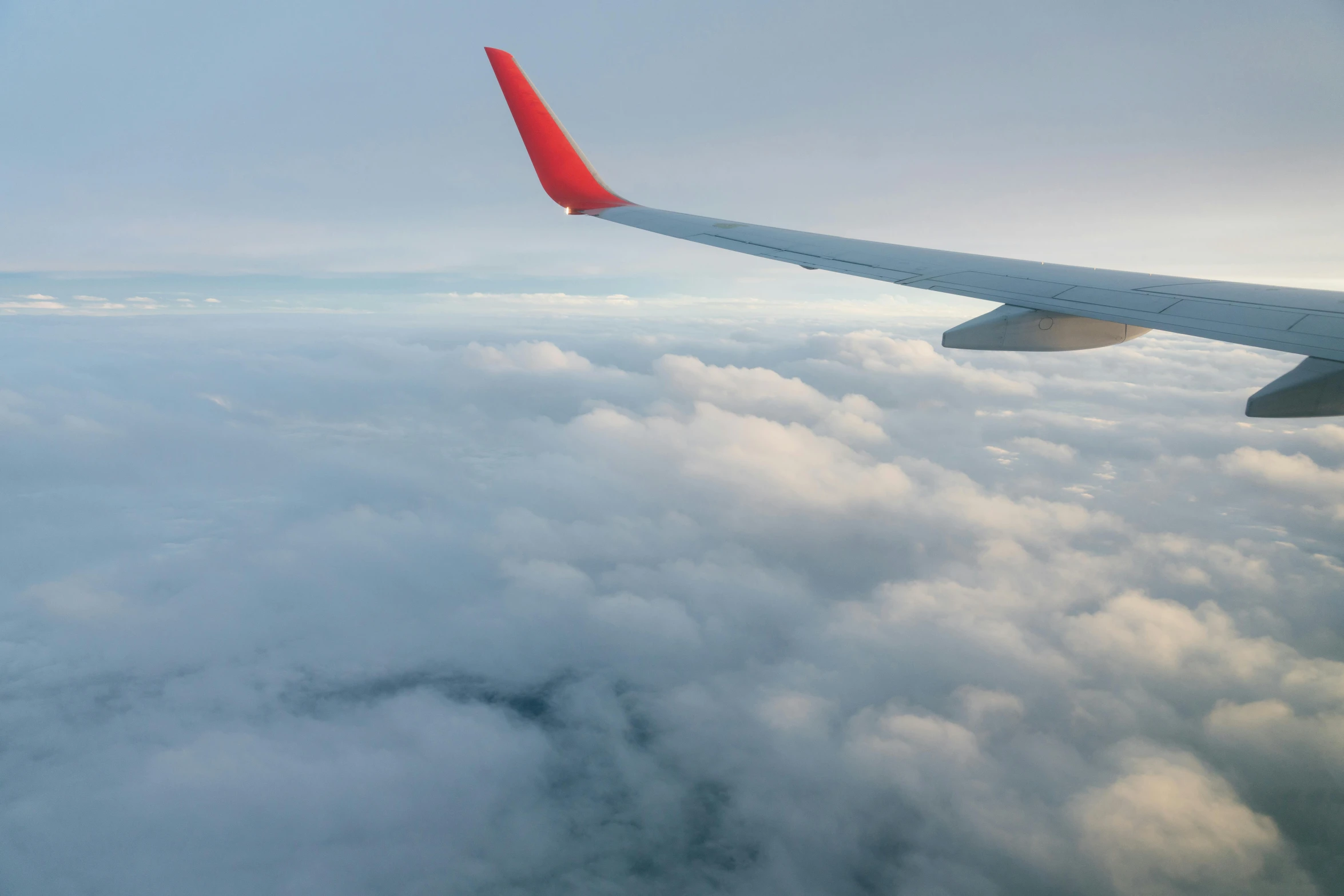 the wing of an airplane flying above the clouds, by Carey Morris, pexels contest winner, modernism, profile view perspective, avatar image