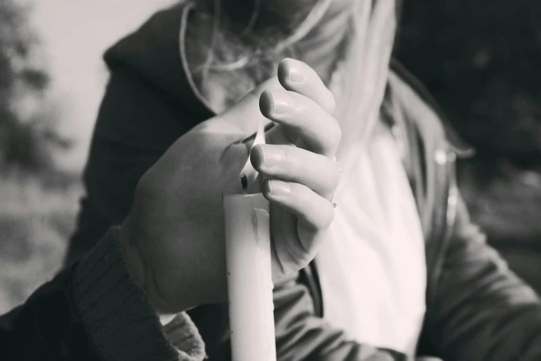 a black and white photo of a woman holding a baseball bat, trending on pexels, process art, candle dripping white wax, smoking a joint, candle, teenage girl