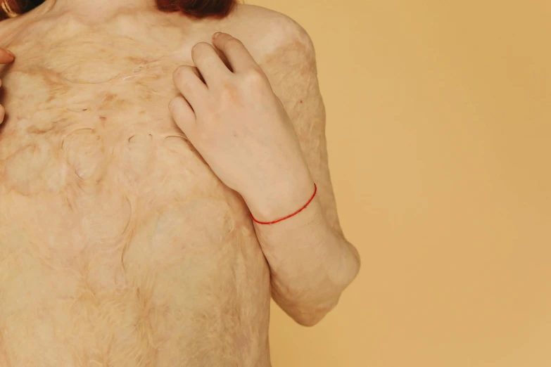 a woman that is standing up with her hands on her chest, an album cover, by Elsa Bleda, trending on pexels, serial art, red veins, patricia piccinini, body hair, bandage on arms