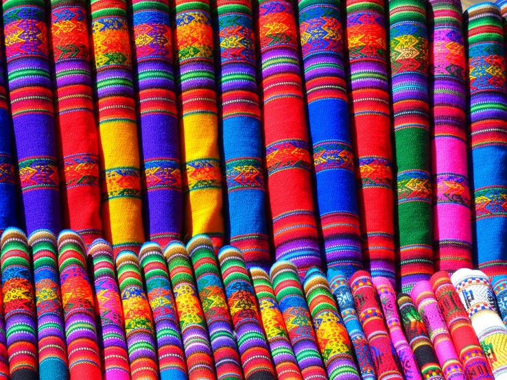 a bunch of colorful fabrics stacked on top of each other, a digital rendering, by Pacita Abad, flickr, peru, market, very colorful heavenly, in a row